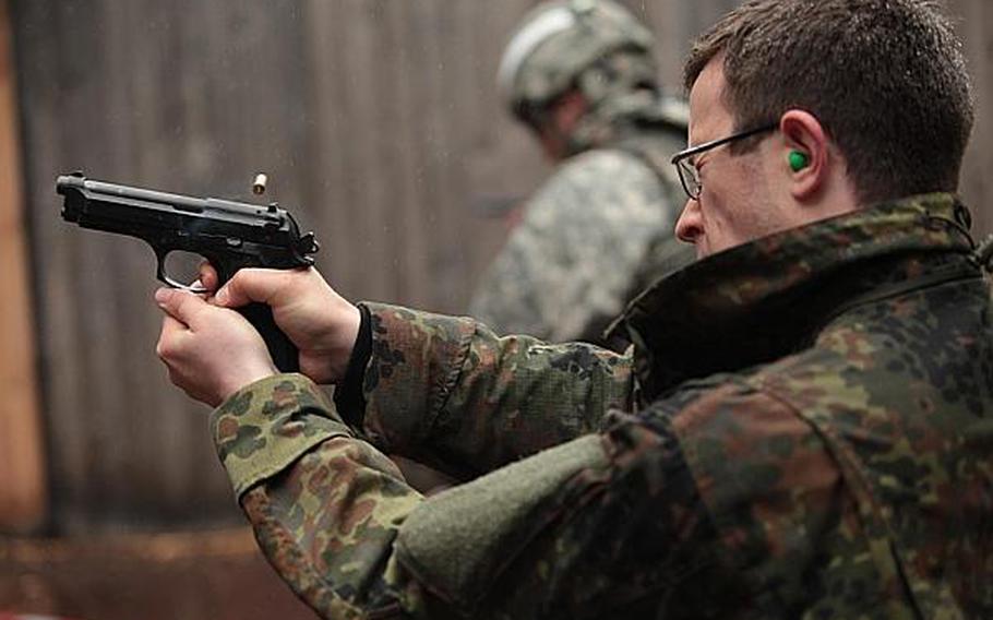 A shooter squeezes off a round with an American M9 pistol at the Monte Kali shooting competition Friday in Wackernheim, Germany. Matt Millham/Stars and Stripes