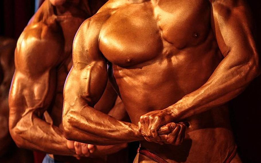 Men show off their biceps in side view Saturday at the 2013 Bodybuilding and Figure Invitational in Kaiserslautern.