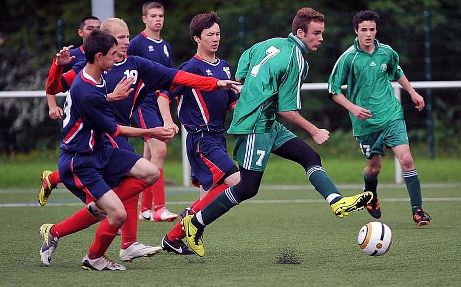 SHAPE's Santiago Gamboa gets past the Aviano defense to tie the Division II game at 2-2. SHAPE won 3-2 on a goal by Ignacio Gamboa, seen at right.