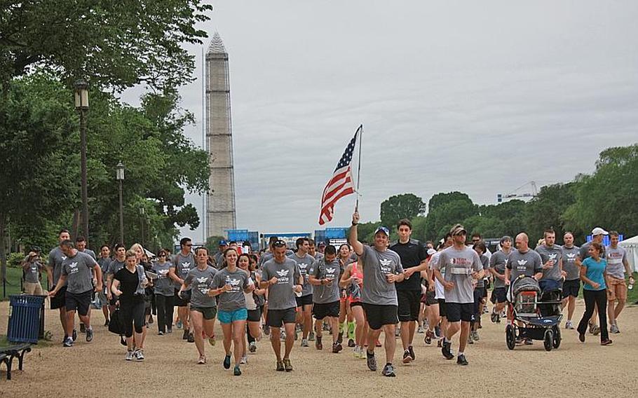Participants in the "Run as One" event in Washington, D.C., on May 18 crossed the finish line 
                together. The event was designed to boost suicide awareness and veterans resources.