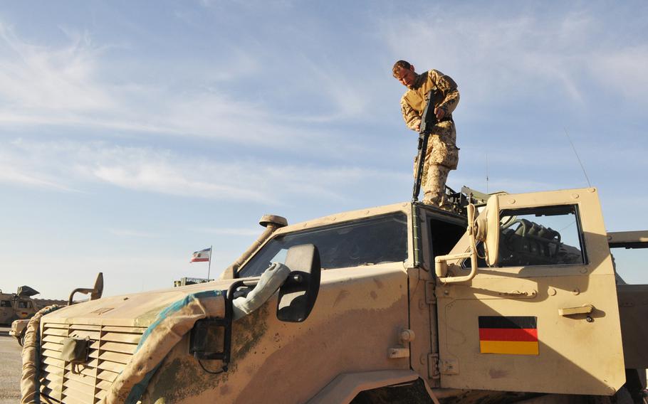 Staff Sgt. Marco L. prepares his gun on top of a German Dingo truck before a force protection mission in Mazar-e-Sharif.