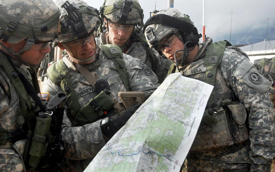 Second Lt. Joey Ivanov, second from left, of 2nd Platoon, Troop L, studies a map of the Hohenfels Training Area in Germany during the 2nd Cavalry Regiment's pre-deployment exercise in March.
