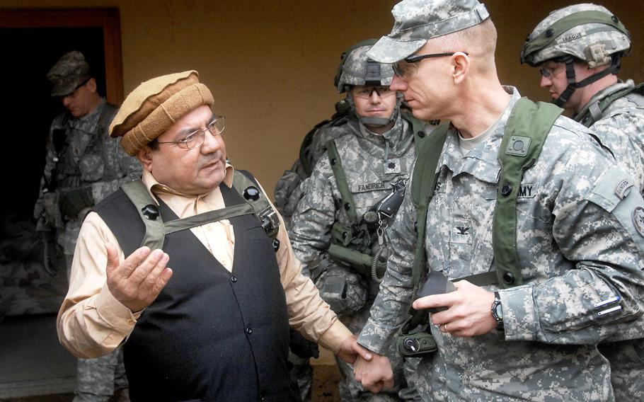 Col. Douglas A. Sims, right, commander of the 2nd Cavalry Regiment, speaks with a role-player acting as an Afghan government official  during the unit's pre-deployment exercise in Hohenfels, Germany, in March. The three-week training sought to simulate conditions in the area of southern Afghanistan where 2nd Cavalry is scheduled to deploy this summer.