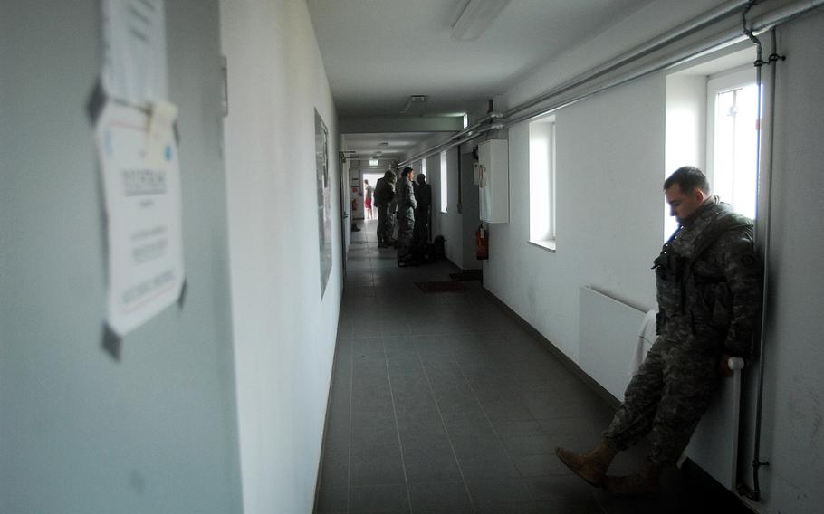 Pvt. Mike Forgach of Troop L waits in a hallway before role-playing resumes during the 2nd Cavalry Regiment's pre-deployment exercise in Hohenfels, Germany, in March. 