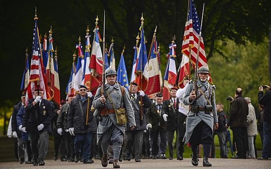French veterans carry flags during a pass and review Sunday morning after an American Memorial Day ceremony at the Meuse-Argonne American Cemetery and Memorial in France. Joshua L. DeMotts/Stars and Stripes