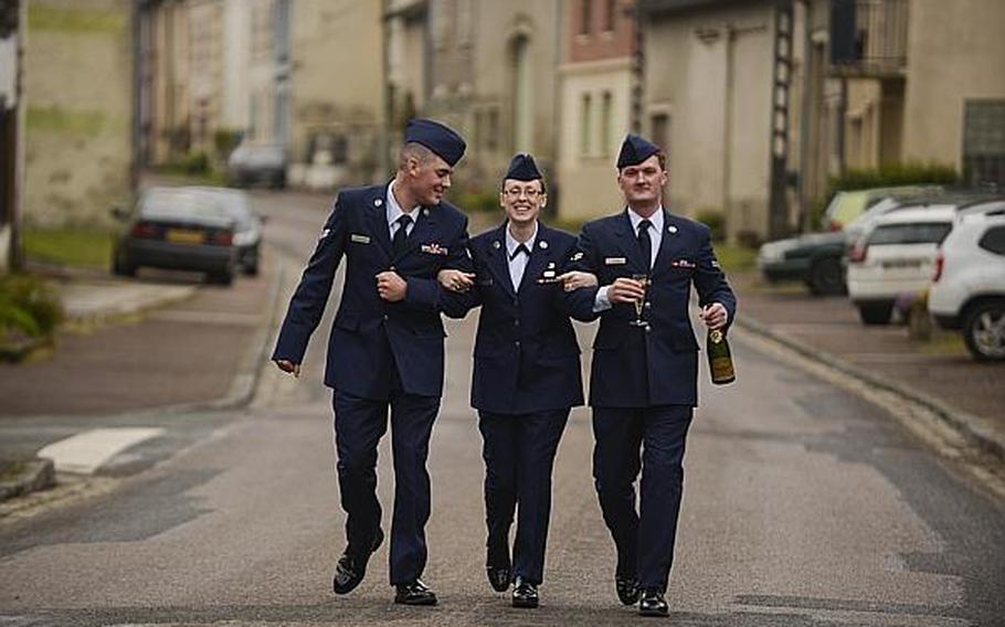 From left to right, U.S. Air Force Senior Airman Aaron Dickerson, Airman 1st Class Bonnie Burks, Airman 1st Class Josiah Austin, from Ramstein Air Base, Germany, walk to their bus after a French-hosted reception that followed an American Memorial Day Ceremony at the Meuse-Argonne American Cemetery and Memorial in France. A large group of Airmen from Ramstein volunteered to participate in the ceremony held Sunday morning. Joshua L. DeMotts/Stars and Stripes