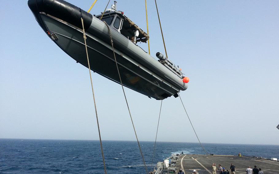 Sometimes boats do fly. The deck crew on the USS Ponce uses a crane to bring a Rigid Hull Inflatable Boat aboard the ship. The USS Ponce was participating in an international mine countermeasures exercise in the Persian Gulf.