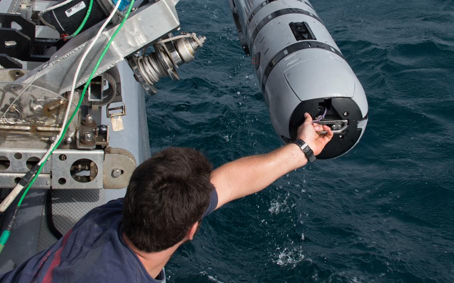 An Unmanned Underwater Vehicle (UUV) operator recovers a UUV after a successful run on May 17th, during an international mine countermeasures exercise.