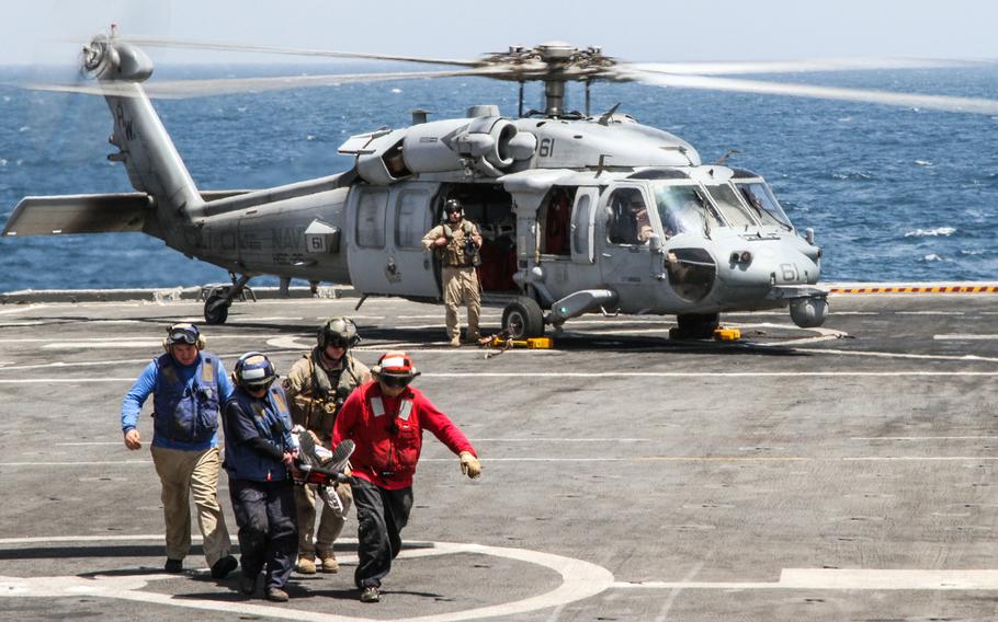 Stretcher bearers aboard the USS Ponce carry a simulated casualty to awaiting medical personnel inside the ship May 19, 2013. This was one of many maritime security drills at the U.S. 5th fleet led an international mine countremeasure exercise in the Persian Gulf.