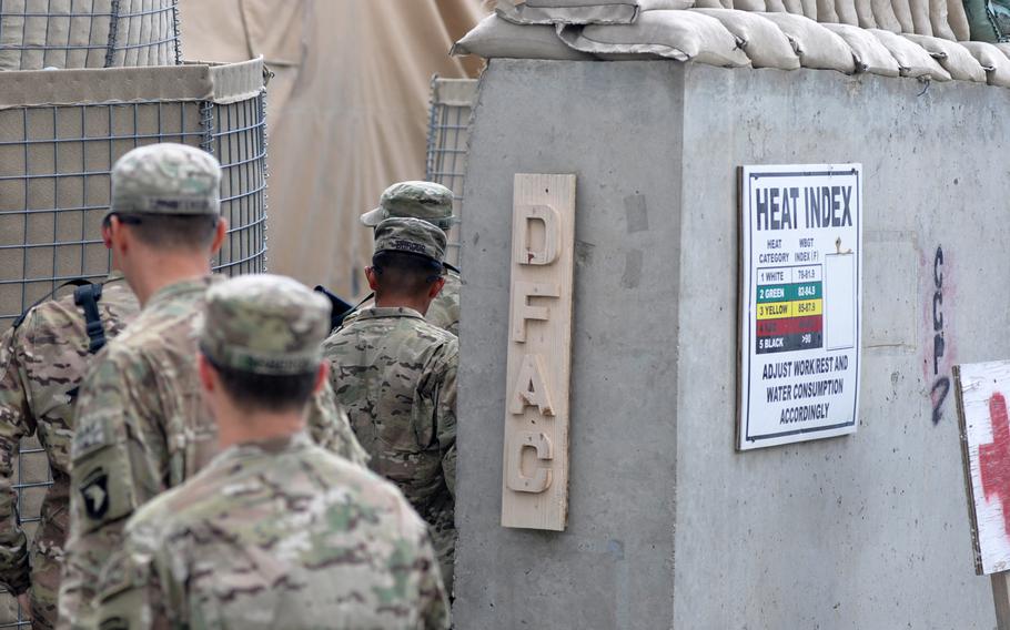 Soldiers with the 1st Combat Brigade Team, 101st Airborne Division, file into the dining facility at Forward Operating Base Joyce in eastern Afghanistan. A sudden influx of troops at the base as other outposts have closed often created long lines at places like the dining hall.