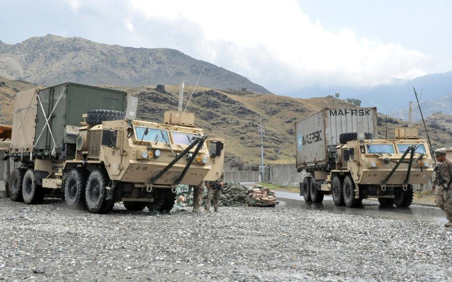Soldiers with the 1st Combat Brigade Team, 101st Airborne Division position armored trucks at Forward Operating Base Joyce in eastern Afghanistan. Convoys leave daily laden with shipping containers as troops prepare to hand over the base to the Afghan National Army.