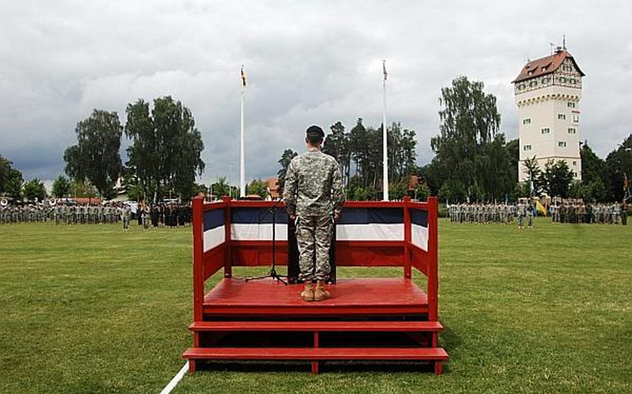 Brig. Gen. Walter E. Piatt stands at attention after assuming command of the Joint Multinational Training Command in Grafenw?hr, Germany, on Wednesday, June 26, 2013.