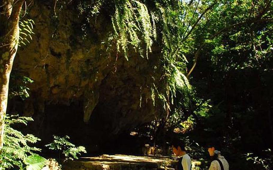 Visitors to Sefa Utaki stand where cooks once prepared meals for the Ryukyu king.