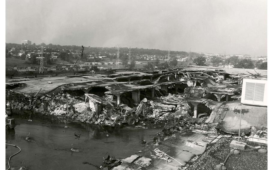 Burned and wet files were scooped up with front-end loaders and taken to a nearby makeshift tent city for drying.