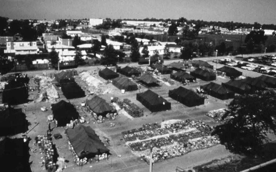 Workers in a tent city at the center's parking lot worked to index and dry out more than 6 million files salvaged from the 1973 fire.