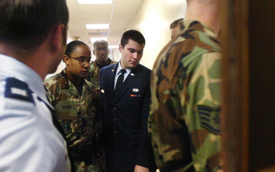 Airman Andrew Witt is led into a courtroom before being found guilty of murdering Airman Andrew Schliepsiek and his wife, Jamie in 2004.