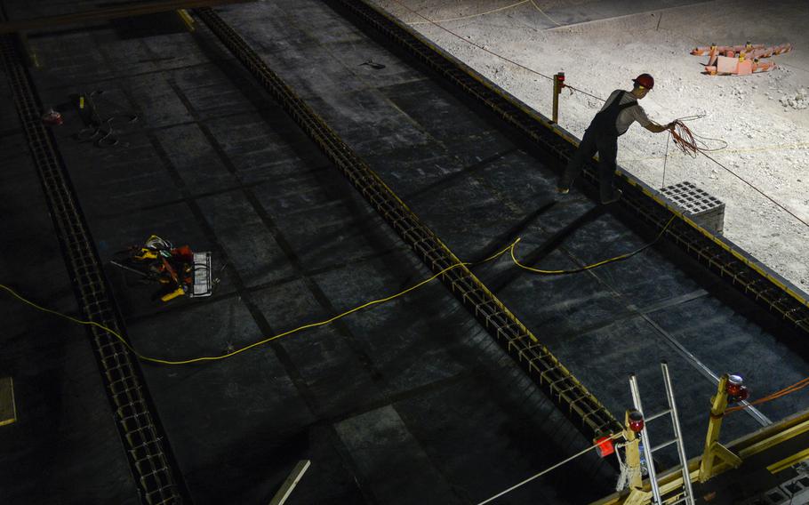 A member of the 557th Expeditionary Red Horse Squadron builds a 20-bed Contingency Aeromedical Staging Facility at an undisclosed location in Southwest Asia. The building will become a hub for seriously injured U.S. personnel in the Middle East once America withdraws the bulk of its forces from Afghanistan.