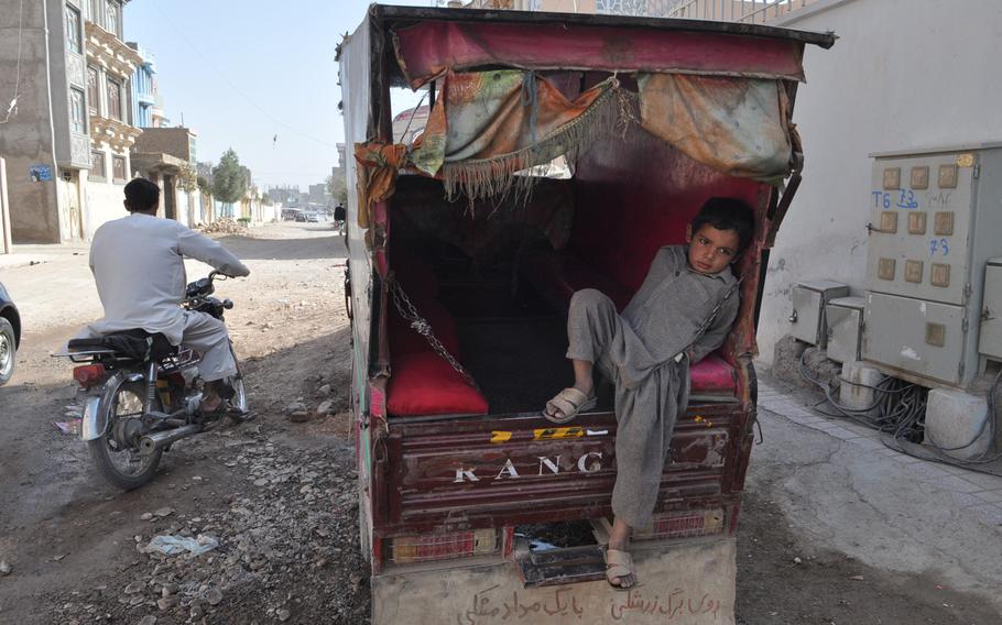 A young boy rests in a seh charkh (three wheels), the ubiquitous auto-rickshaws that ply the streets of Herat, a regional capital in western Afghanistan.