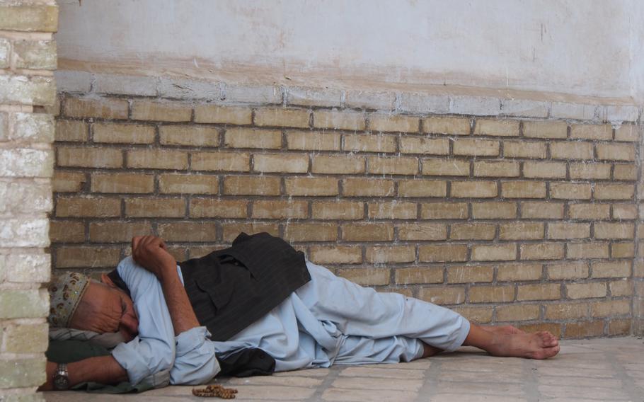 A man sleeps in a corridor of the massive Jami Mosque in Herat, Afghanistan.