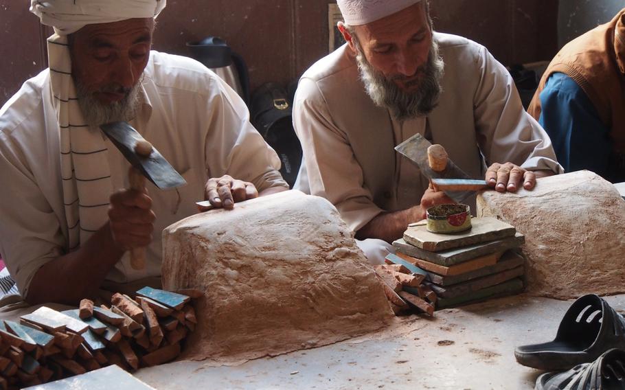 Men make tiles in a workshop at the Jami Mosque, in Herat, Afghanistan. The tiles are made by hand, as they have been for hundreds of years, and used to repair broken sections of the mosque walls.