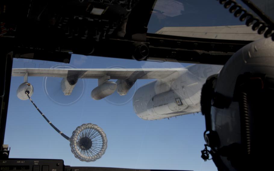 A pilot with Marine Medium Tiltrotor Squadron 161 aims to connect to a KC-130J Super Hercules to receive fuel in flight aboard Marine Corps Air Station Miramar, Calif., on Oct. 24, 2013.