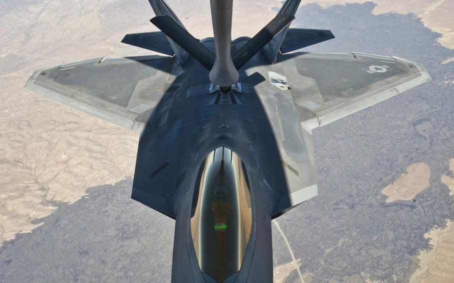 An F-22 Raptor assigned to the 49th Fighter Wing at Holloman Air Force Base, N.M., receives fuel from a KC-135 Stratotanker from McConnell Air Force Base, Kan., on Oct. 23, 2013.