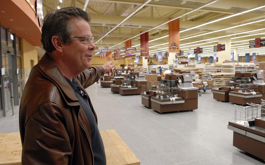 Harry Nichols Jr., the Ramstein commissary director, points to a line of new registers in the remodeled and expanded store on Ramstein Air Base, Germany. The renovated facility is scheduled to open Nov. 15.