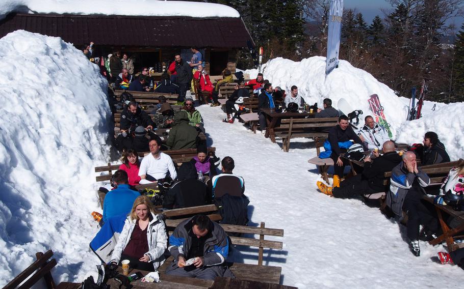 Skiers and snowboarders relax and enjoy some refreshment and some sun at Bjelasnica ski resort near Sarajevo, Bosnia-Herzegovina.