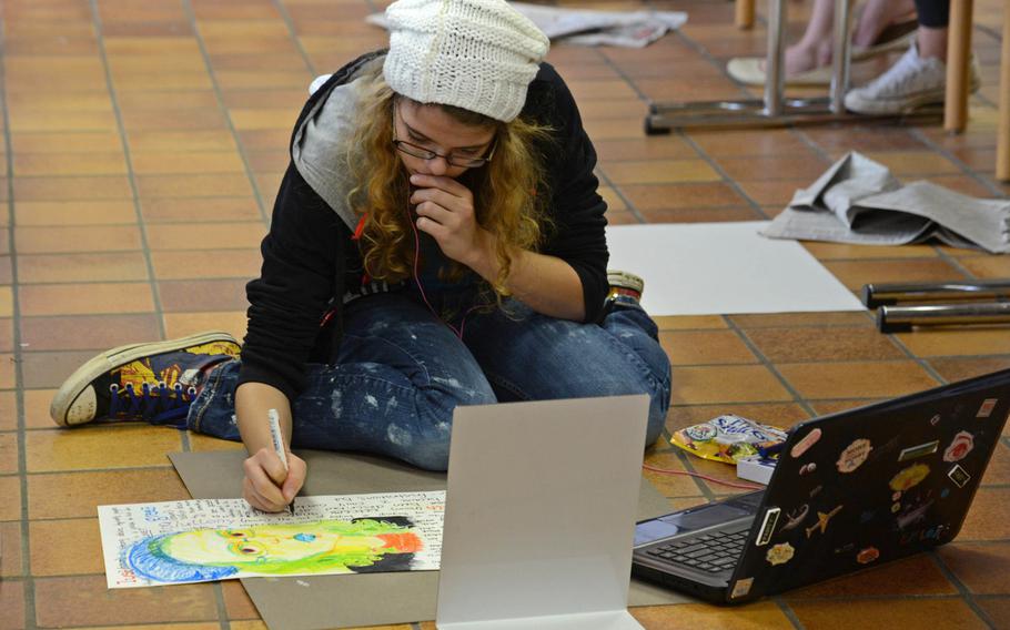 In the mixed media workshop at Creative Connections Alexa Gunn of Hohenfels works on a self-portrait. More than 160 students from DODDS-Europe high schools participated in this year's event that features 11 workshops in the visual and performing arts.