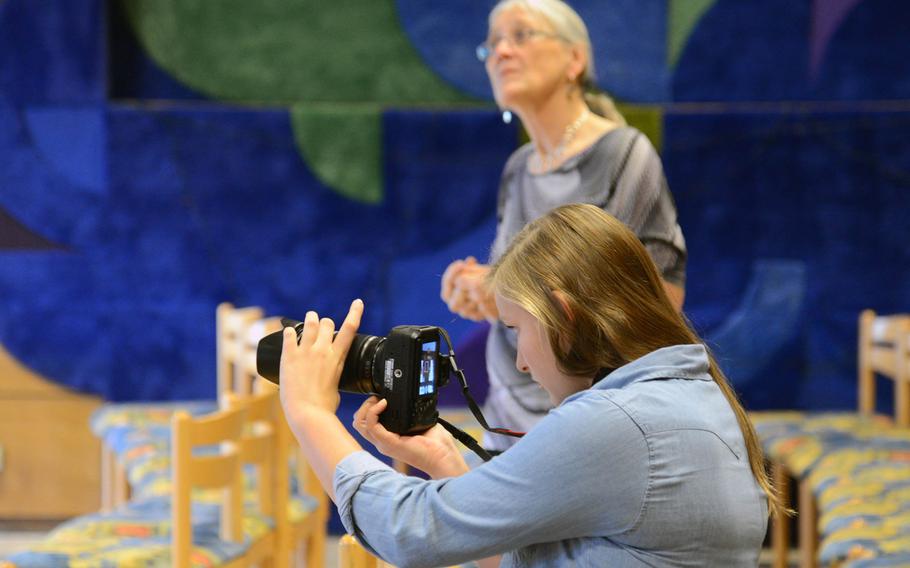 Incirlik's Emilia Klemcke , a participant in the video production workshop at Creative Connections, records the show choir as its instructor Donna Andre listens and watches the action on stage. More than 160 students from DODDS-Europe high schools participated in this year's event that features 11 workshops in the visual and performing arts.