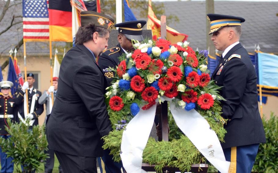 James Mann, left, commander of Veterans of Foreign Wars Post 27; Command Sgt. Maj. Sa?eed A. Mustafa, center, U.S. Army Garrison Wiesbaden command sergeant major; and Col. David H. Carstens, garrison commander, lay a wreath Thursday, Nov. 7, 2013, to commemorate the upcoming Veterans Day holiday during a ceremony at Veterans Park on Clay Kaserne in Wiesbaden, Germany.