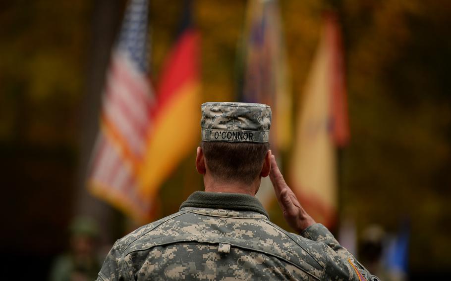 Maj. Gen. John R. O'Connor, commander of the 21st Theater Sustainment Command, salutes the colors Thursday during his unit's Veterans Day observance at Panzer Kaserne, Germany, Thursday, Nov. 7, 2013.