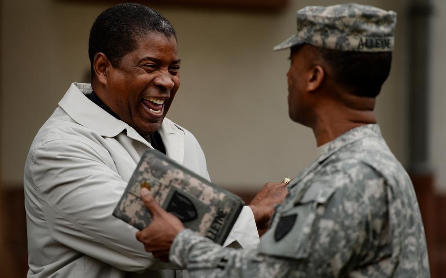 Retired Command Sgt. Maj. Arthur F. Peete, left, shakes hands with Maj. Eric Alleyne at the end of the 21st Theater Sustainment Command Veterans Day observance at Panzer Kaserne, Germany, Thursday, Nov. 7, 2013. Peete was special guest at the observance.