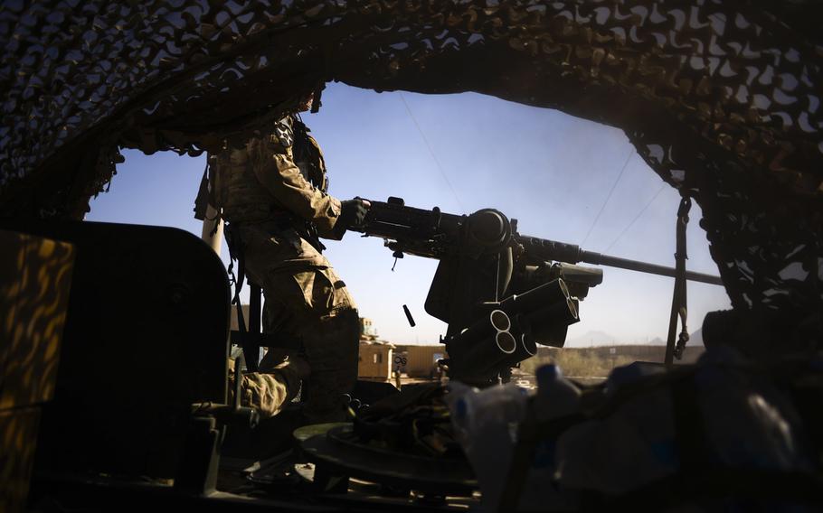 Sgt. Alex Hatfield with 3rd Squadron, 2nd Cavalry Regiment test fires a mounted 50-caliber machine gun from a Stryker before leaving Forward Operating Base Pasab to conduct a partnered patrol with Afghan police in the local area north of the FOB in the Zhari southern Afghanistan's Kandahar province on Oct. 21, 2013.