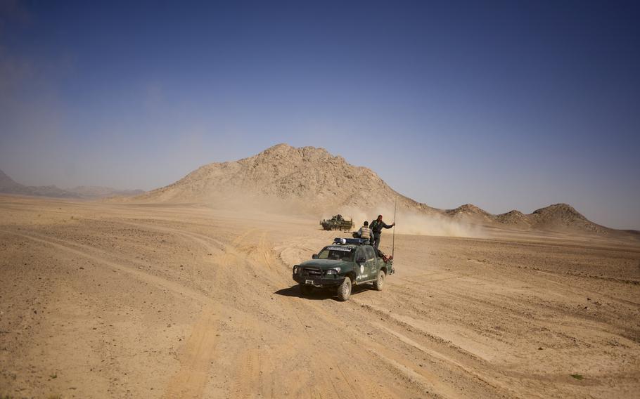 Afghan police ride in a Ford Ranger during a recent partnered patrol with 3rd Squadron, 2nd Cavalry Regiment based at Forward Operating Base Pasab in the desert of Kandahar province's Zhari district on Oct. 21, 2013.