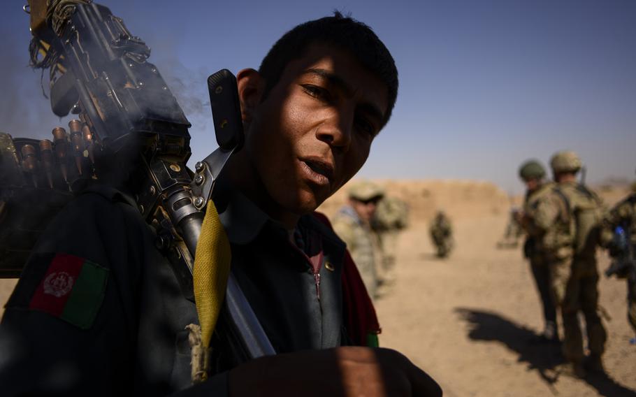 An Afghan policeman smokes hashish during a partnered patrol with 3rd Squadron, 2nd Cavalry Regiment just north of Forward Operating Base Pasab located in southern Aghanistan's Zhari district on Oct. 21, 2013.