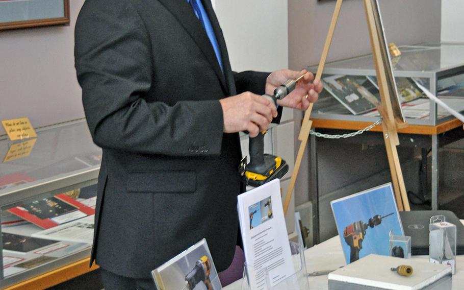 Army veteran Walter Nagel III shows off his "SHUR-A-TAK" universal screw attachment to a potential investor at the Veterans Venture Forum event on Oct. 29. The event paired veteran entrepreneurs with individuals and firms looking to invest in new start-ups.