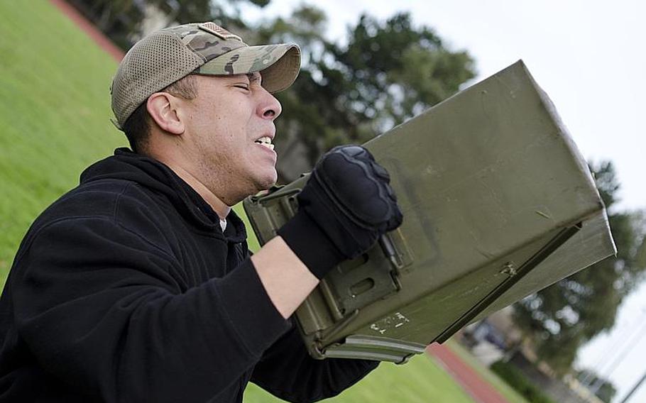 Staff Sgt. Leo Leija lifts 30 pounds as part of the 48th Medical Surgical Operations Squadron team's effort to win the CFC Combat Fitness Challenge at RAF Lakenheath, England, on Friday, Nov. 8, 2013. The team had to life the boxes 200 times.