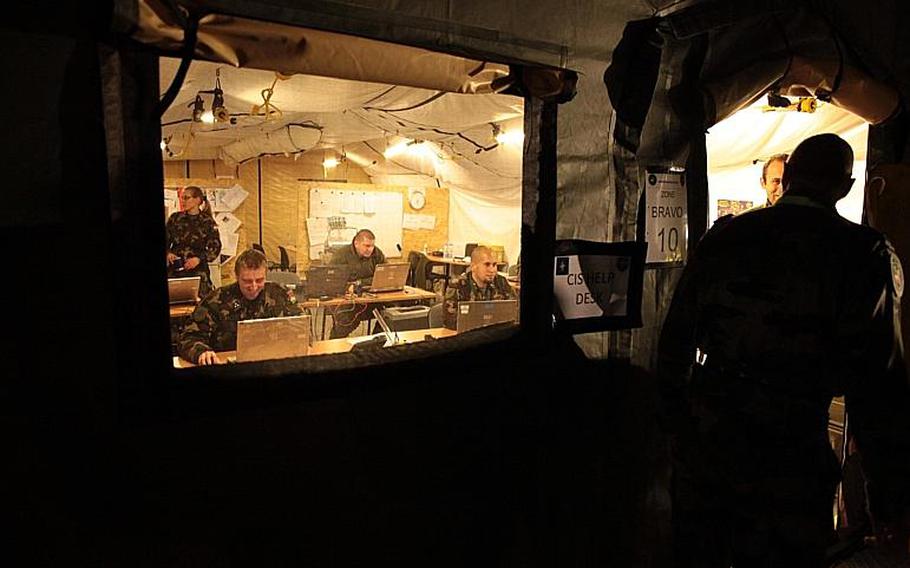 NATO personnel work in a tent during the Steadfast Jazz 2013 exercise, which served as a test of the alliance's ability to rapidly deploy command and control elements to war or other crises. Matt Millham/Stars and Stripes