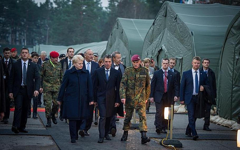 German Gen. Hans-Lothar Domr?se, commander of NATO's Joint Force Command Brussum, leads NATO Secretary-General Anders Fogh Rasmussen, center, and the presidents of Lithuania and Estonia and Latvia on a tour of his temporary headquarters at Camp Adazi, Latvia, on Nov. 6, 2013. Emily Langer/NATO
