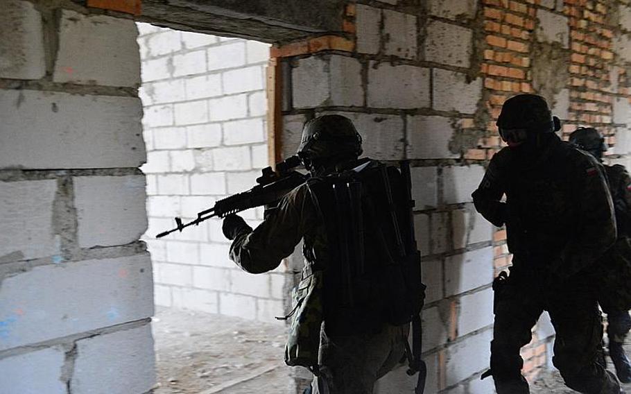 Polish military police search and clear a building during NATO's Steadfast Jazz military exercise in Poland Nov. 2, 2013. Photo courtesy NATO