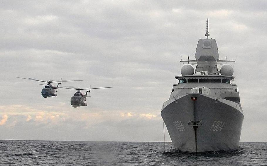 Two Mi-14 HAZE helicopters pass close to the the Dutch frigate HNLMS De Ruyter on Nov. 6, 2013, during maritime maneuvers that were part of NATO's Steadfast Jazz 2013 exercise. Photo courtesy of NATO