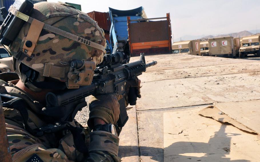 Convoy commander Sgt.1st Class Christopher D.L. Perez uses the scope on his rifle to scout out the area inside the Afghan National Army's Central Issuing Facility when a bullet from an unknown shooter whizzed nearby. Perez was on a guardian angel mission to protect a lieutenant colonel who was visiting the compound to meet with leaders in the Afghan Army. No one was injured.