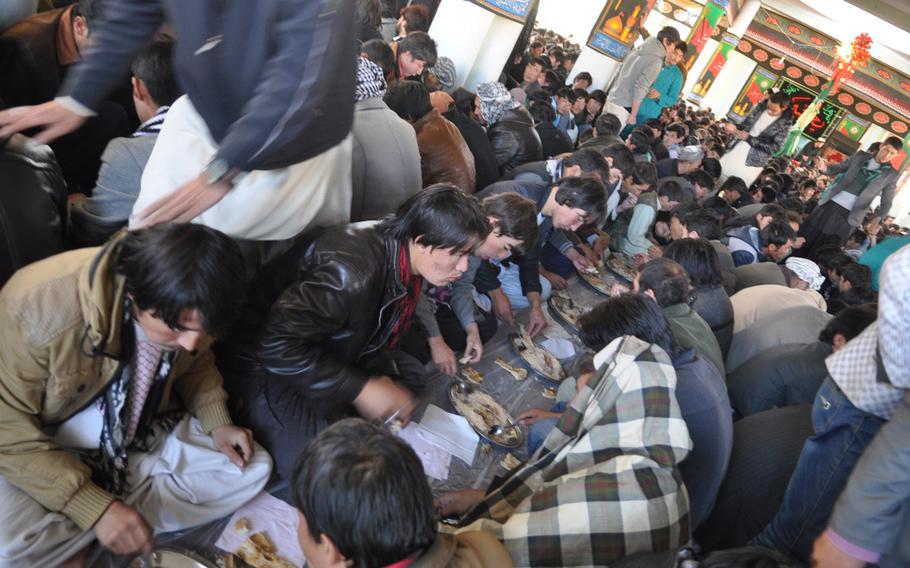 Shia Muslims in Bamiyan, Afghanistan sit down to a meal in a mosque after Ashura services Thursday. Ashura is one of the holiest days of the year for Shias.