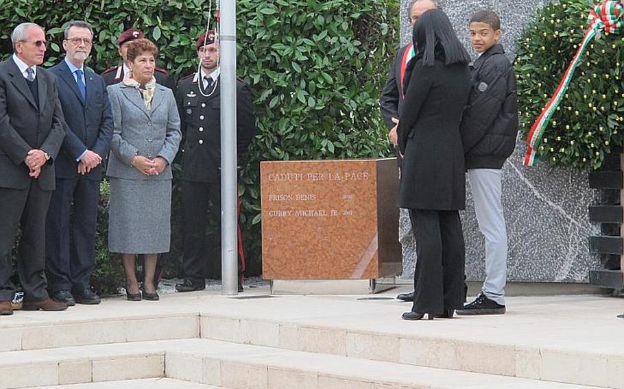 Curry's son, Kevin, looks out from the podium during the ceremony, with his widowed mother, Lucia, at his side. Left are Tranquillo Frison, who thought of and paid for the monument to his son and Curry, the prefect of Padua and Frison's wife.