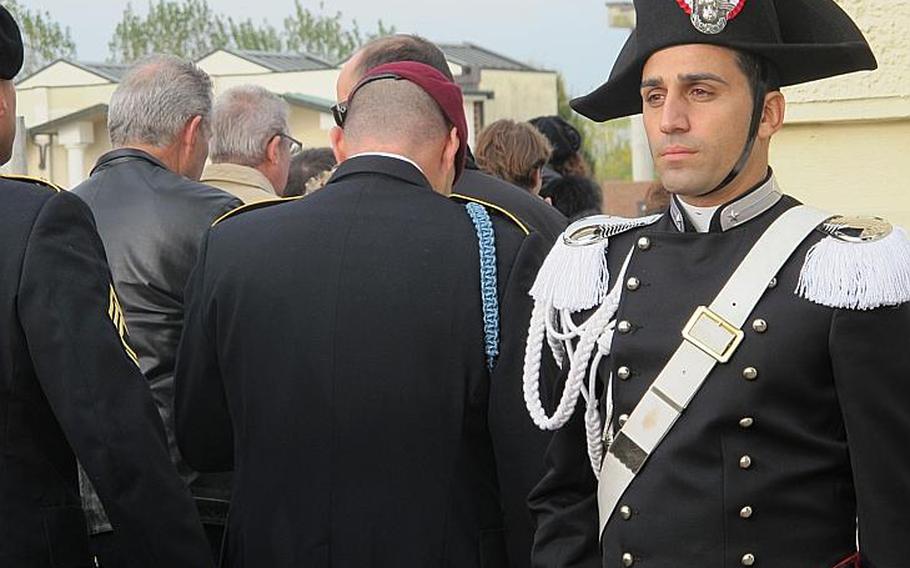 An Italian Carabinieri stands post at the entrance to the Grantorto cemetery as Iocals and 173rd soldiers file in. They were preceded by a brass marching band which next lead the group to the town piazza to unveil a new monument to 1st Sgt. Michael Curry and Carabiniere Denis Frison. Both were "Caduti Per La Pace" - fallen in the cause of peace, according to the monument's inscription.