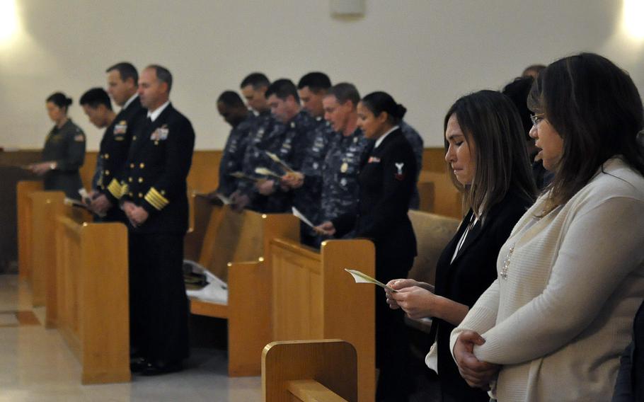 Jennifer Cruz, holding the program in the foreground, participates in a Nov. 12, 2013, ceremony commemorating the 1988 bombing of the city's USO club, which killed her sister, Petty Officer 3rd Class Angela Santos, and four Italians. Maurizio Garzelli, a USO accountant and survivor of the attack, also spoke during the program.