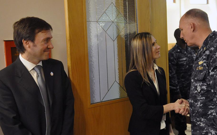 Jennifer Cruz and Maurizio Garzelli, left, greet Navy personnel in Naples, Italy, following a Nov. 12, 2013, ceremony commemorating the 1988 bombing of the city's former USO club. Cruz's sister, Petty Officer 3rd Class Angela Santos, was one of five people killed in the blast. Garzelli was working at the club on the night of the attack.
