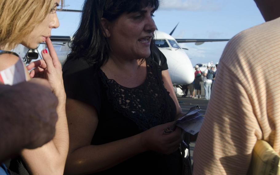 A woman buys a commercial plane ticket to Manila, Philippines from Tacloban Airport November 16, 2013, to avoid waiting on a military flight out of the storm-ravaged city.
