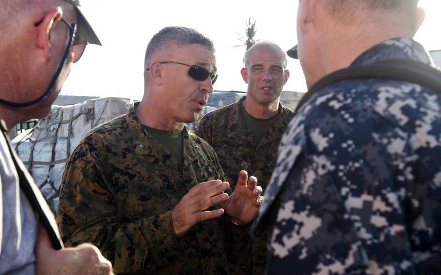 Marine Brig. Gen. Paul Kennedy, commander of Operation Damayan, the typhoon relief effort in the Philippines, discusses operations with personnel assisting in the relief effort at Tacloban Airport on Nov. 15, 2013. Eric Guzman/Stars and Stripes